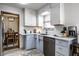 Light and airy kitchen with stainless steel appliances, subway tile backsplash, and light blue cabinets, open to the dining area at 1031 N Lesley Ave, Indianapolis, IN 46219