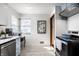 Well lit kitchen with stainless steel appliances, subway tile backsplash and light blue cabinets, featuring a decorative shelf at 1031 N Lesley Ave, Indianapolis, IN 46219