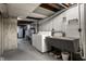 Laundry room includes washer, dryer, utility sink, and storage rack at 1031 N Lesley Ave, Indianapolis, IN 46219