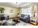 Bright living room includes a comfortable sofa, armchairs, and sleek lighting fixture at 1031 N Lesley Ave, Indianapolis, IN 46219