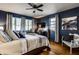 Comfortable main bedroom with stylish blue walls, hardwood floors, and lots of natural light at 1031 N Lesley Ave, Indianapolis, IN 46219