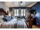 Bright main bedroom featuring a tray with drinks, a large bed, and an ornate wooden bed frame at 1031 N Lesley Ave, Indianapolis, IN 46219