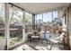 Relaxing screened-in sunroom with outdoor views and seating at 1031 N Lesley Ave, Indianapolis, IN 46219