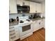 Well-equipped kitchen features granite countertops, white cabinets, and stainless steel appliances at 1041 Hervey St, Indianapolis, IN 46203