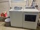 A well-lit laundry room with new, white GE washer and dryer units at 1041 Hervey St, Indianapolis, IN 46203