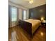 Comfortable primary bedroom with hardwood floors, warm lighting, and ample natural light at 1041 Hervey St, Indianapolis, IN 46203