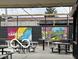 Outdoor patio with picnic tables and art on the fence at 1041 Hervey St, Indianapolis, IN 46203