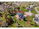 Aerial view showcases the beautiful home in a wooded lot outlined in red at 10417 Mayapple Ct, Noblesville, IN 46060