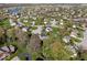 Aerial view of a neighborhood featuring a lake, mature trees, landscaping, and lush green lawns at 10417 Mayapple Ct, Noblesville, IN 46060