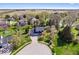 Aerial view of a two-story home with an attached garage, mature trees, landscaping, and a circular driveway at 10417 Mayapple Ct, Noblesville, IN 46060