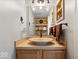 Stylish powder room with a vessel sink, decorative mirror, and charming accents at 10417 Mayapple Ct, Noblesville, IN 46060