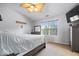Cozy bedroom with ceiling fan, window view, dresser and bed at 10417 Mayapple Ct, Noblesville, IN 46060
