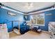 Blue bedroom with a wooden bed, shelf, and a window providing natural light at 10417 Mayapple Ct, Noblesville, IN 46060
