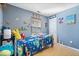 Colorful bedroom with blue walls, playful decorations, and a bright window at 10417 Mayapple Ct, Noblesville, IN 46060