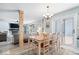 Open-concept dining area with wood floors, leading to a living room and outdoor access at 10417 Mayapple Ct, Noblesville, IN 46060