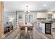 Dining area with table, chairs, and kitchen island bar at 10417 Mayapple Ct, Noblesville, IN 46060