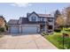 Beautiful two-story home featuring a three-car garage, brick facade, and lush green lawn at 10417 Mayapple Ct, Noblesville, IN 46060