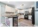 Bright kitchen with white cabinetry, modern appliances, and a breakfast bar at 10417 Mayapple Ct, Noblesville, IN 46060