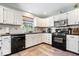 Bright kitchen with white cabinets, black countertops, and updated appliances at 10417 Mayapple Ct, Noblesville, IN 46060