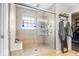 Bright tile shower featuring a glass door and built in shower bench at 10417 Mayapple Ct, Noblesville, IN 46060