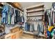 Wood flooring highlights this walk-in closet with built in shelves and hanging racks at 10417 Mayapple Ct, Noblesville, IN 46060