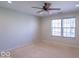 This bedroom features neutral paint, a ceiling fan, and natural light from the windows at 105 Fountain Dr, Mooresville, IN 46158