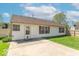 Rear view of a home with a white siding, red shutters, and a large concrete patio at 105 Fountain Dr, Mooresville, IN 46158