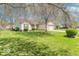 Charming single-Gathering home with a well-manicured lawn, mature trees, and an attached two-car garage at 105 Fountain Dr, Mooresville, IN 46158