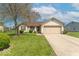 Attractive home featuring a well manicured lawn, mature tree, and convenient two car garage at 105 Fountain Dr, Mooresville, IN 46158