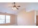 Spacious living room area featuring large windows, a ceiling fan, and neutral wall color at 105 Fountain Dr, Mooresville, IN 46158