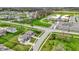 Aerial view of a home in a suburban neighborhood with a school nearby at 10811 Wild Orchard Ln, Indianapolis, IN 46239