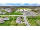 Aerial view of a home in a suburban neighborhood with a school nearby at 10811 Wild Orchard Ln, Indianapolis, IN 46239