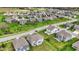 Aerial view of a community with well-maintained homes, green lawns, and a playground in the backyard at 10811 Wild Orchard Ln, Indianapolis, IN 46239