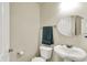 Bathroom featuring a vanity sink, a round mirror, and a toilet at 10811 Wild Orchard Ln, Indianapolis, IN 46239
