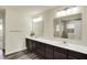 A luxurious bathroom features a double sink vanity, spacious mirror, and a glass-enclosed shower for a spa-like experience at 10811 Wild Orchard Ln, Indianapolis, IN 46239