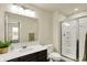 Well-lit bathroom featuring a sink with countertop, a toilet, and a glass-enclosed shower stall at 10811 Wild Orchard Ln, Indianapolis, IN 46239
