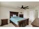 Bedroom features a ceiling fan, bed with blue comforter, and large window allowing lots of natural light at 10811 Wild Orchard Ln, Indianapolis, IN 46239