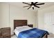 Comfortable bedroom with a ceiling fan, a bed with side tables, and a closet door providing ample storage at 10811 Wild Orchard Ln, Indianapolis, IN 46239