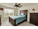 Bedroom featuring a ceiling fan, bed with blue comforter, and large window allowing lots of natural light at 10811 Wild Orchard Ln, Indianapolis, IN 46239