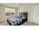 Comfortable bedroom with a cozy bed, natural light from the window, and a conveniently located closet at 10811 Wild Orchard Ln, Indianapolis, IN 46239