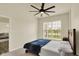 Bright bedroom featuring a ceiling fan, a comfortable bed with a blue coverlet, and a window with a view at 10811 Wild Orchard Ln, Indianapolis, IN 46239