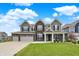 Beautiful two-story home with brick and siding, three-car garage, and well-manicured lawn at 10811 Wild Orchard Ln, Indianapolis, IN 46239