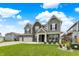 Charming two-story home with brick accents, a three-car garage, and landscaped front yard at 10811 Wild Orchard Ln, Indianapolis, IN 46239