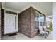 Inviting front porch featuring brick accents and comfortable seating for relaxing outdoors at 10811 Wild Orchard Ln, Indianapolis, IN 46239