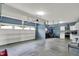 Spacious garage area with an overhead door, cabinets, and a kitchen featuring stainless steel appliances at 10811 Wild Orchard Ln, Indianapolis, IN 46239