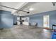 Large garage area with white cabinets, stainless steel appliances, and a gray sofa at 10811 Wild Orchard Ln, Indianapolis, IN 46239