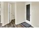 Hallway featuring tile flooring and access to a bathroom and exterior door at 10811 Wild Orchard Ln, Indianapolis, IN 46239