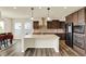 Spacious kitchen with a center island, stainless steel appliances, and warm brown cabinetry at 10811 Wild Orchard Ln, Indianapolis, IN 46239