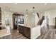 Well-lit kitchen showcasing stainless steel appliances, a center island, and hardwood floors at 10811 Wild Orchard Ln, Indianapolis, IN 46239