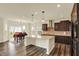 Bright kitchen featuring a center island with pendant lighting and an adjacent dining area at 10811 Wild Orchard Ln, Indianapolis, IN 46239